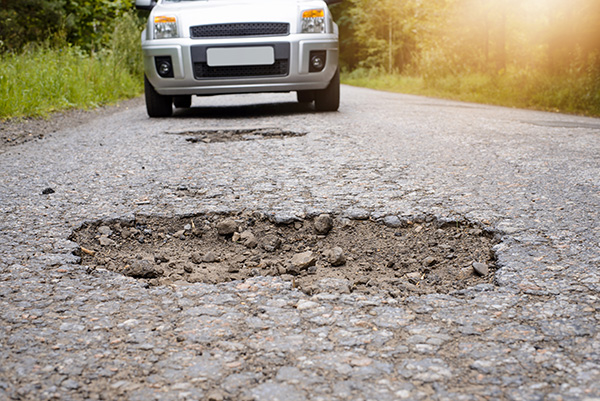 What Should I Check After Hitting a Pothole? | Four Car Garage